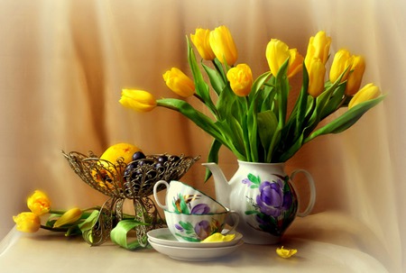 Bright And Beautiful - yellow tulips, tulips, draper, teacups, wire compote, still life, saucer, teapot, lemon, compote, table, flowers