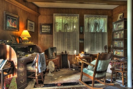 The cabin - cabin, window, weights, books, lamp, rug, bookcase, tv, pants, papers, house, curtains, fan, cushion, chair, messy, desk, pictures, window blinds