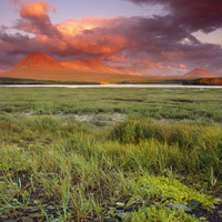 Spectacular sunrise over McNeil River and the Katmai Mountains