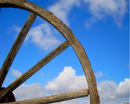 Looking through the wagon wheel - wagon wheel, nature, sky, abstract, clouds, 3d, wheel, photograph