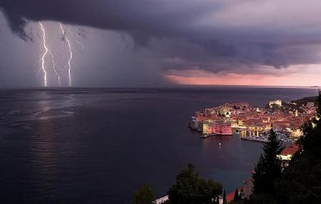 Too Close for Comfort - sky, ocean, trees, night, view, town, blue, clouds, pink, horizen, sea, lightening