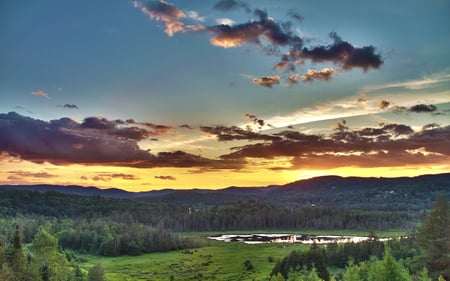 First Sunset of the Summer - clouds, blue, pond, beautiful, colors, forest, sunsets, skies, nature, dusk, golden, mounatins