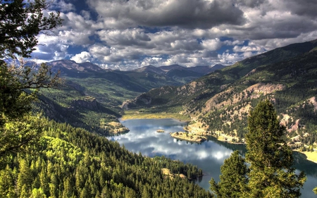 Over Looking the Lake - clouds, trees, water, blue, grass, forest, reflection, nature, green, lake, sky