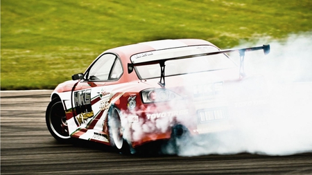 Burning Rubber - rubber, cars, tire, grass, toyota, spinning, nature, car, smoke, race