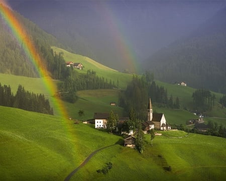 Rainbow Over South Tyrol Austria - sky, rainbow, mountain, trees, buildings, village, forest, architecture, colors, land, grass