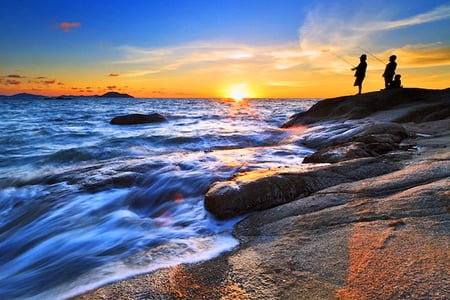 Final cast - sunset, water, golden sky, fishing, boys, blue sky, ocean, rocks