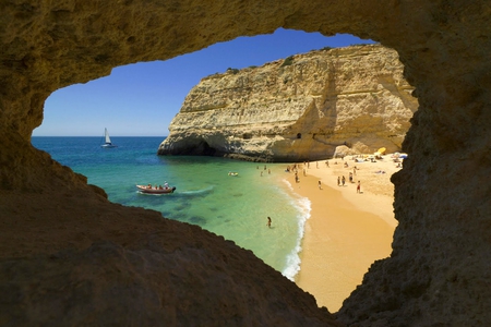 view through a cave - sky, beach, people, photography, water, nature, blue, green, sand