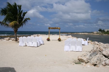 Wedding  in Jamaica resorts  - palm, wedding, ocean, blue, sand, white, sky, chairs, clouds, beaches, photography, tree, nature