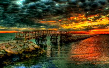 Lovely Sunset - sundown, sunlight, beauty, colors, stones, pier, nature, sunset, bridg, bank, yellow, amazing, splendor, reflection, red, view, twilight, emerald, art, sky, clouds, storm, beautiful, sea, stormy, orange, lovely, ocean, colorful, waves, dusk, peaceful, bridge