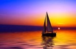 SAILBOAT AGANIST A BEAUTIFUL SUNSET