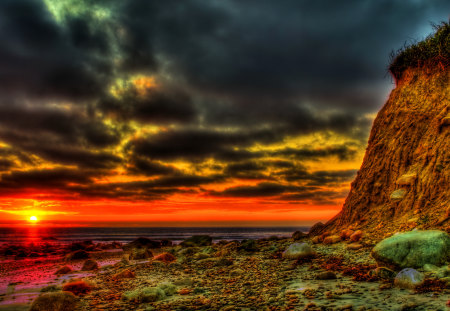 Sunset - beauty, sky, beach, sun, peaceful, colorful, sunset, rocks, storm, amazing, view, clouds, stormy, sand, rays, ocean, sunlight, lovely, nature, beautiful, splendor, stones, colors, sea