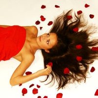 Beautiful girl and rose petals