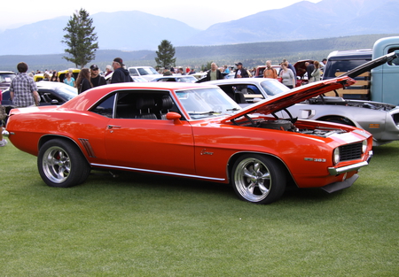 Chevrolet Camaro at the Radium Hot Springs car show 94  - red, automobile, mountains, black, chrome, tires, grass, blue, camaro, chevrolet, car, engine, photography, trees, green