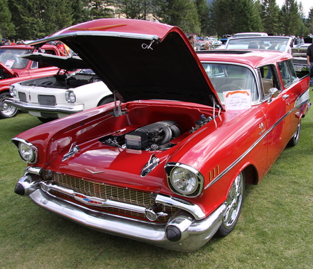 1957 Chevrolet at the Radium Hot Springs car show 103  - nickel, chevrolet, chrome, photography, tires, engine, black, white, headlights, red, green, grass