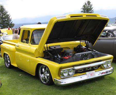 GMC truck at the Radium Hot Springs car show 104  - trees, GMC, tires, yellow, headlights, photography, grass, truck, black, green