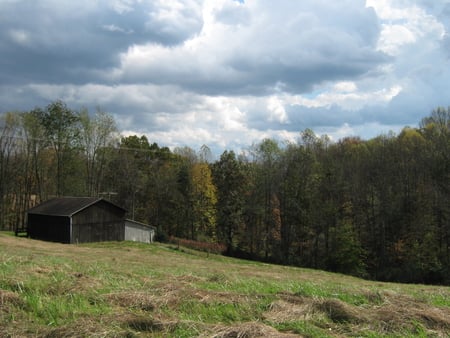 As The Storm Approachs - clouds, trees, hills, brown, hay, golden, buildings