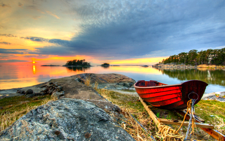 Sunset - rocks, boat, beautiful, leaves, grass, red boat, view, tree, nature, sunset, colorful, red, pretty, water, beauty, peaceful, lake, sky, reflection, sunlight, clouds, lovely, splendor, trees, colors, boats, green