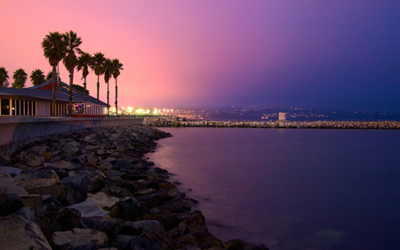 Lovely View - beauty, sky, buiding, trees, peaceful, rocks, villa, view, purple, clouds, architecture, house, tree, ocean, houses, light, night, buildings, lovely, nature, town, beautiful, city, splendor, colors, sea, lights