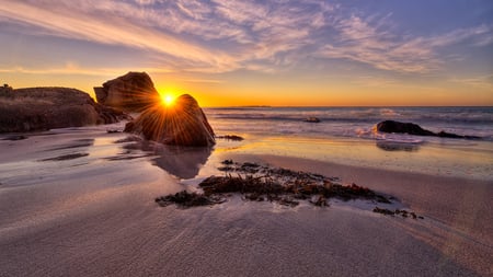 Rays - rays, beach, sky, sunlight, sun, sunset, rocks, reflection, clouds, sunrays, sea, sunrise, sand