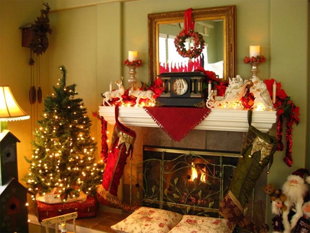 Merry Christmas - pillows, garland, clock, lamp, pointsetta trees, reflection, santa clause, clocks, stockings, mirror, fireplace, red, grate, teddy, teddy bear, flames, candles, tinsel, sleigh, house, gold, statues, santa, wreath, deer, lights, walls, animals