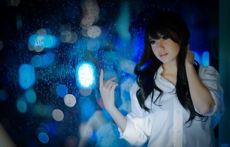 In blue - beauty, hands, t-shirt, lips, eyes, water drops, black hair, face, window, blue, beautiful girl, lights