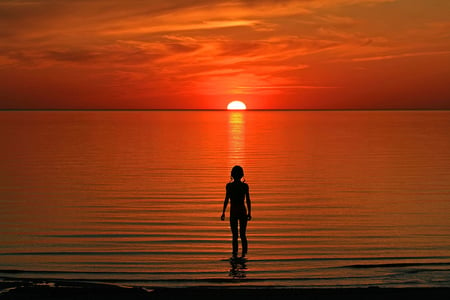 In Awe of Nature... - sky, ocean, silhouette, girl, sun, sunset, bright, magnificient, fiery, beautiful, sea