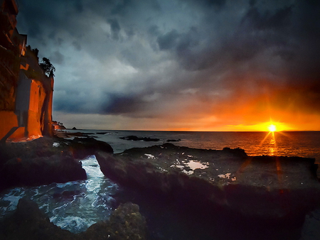 Last sunlight - sunlight, water, coast, beach, last, sea, night, reflection, stones, nature, sun, castle, rocks