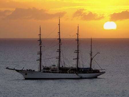 Floating Sunset - sail, ocean, sunset, antique, wood, vintage, twilight, classic, sailboat, sea, sunrise, boat