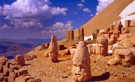 Heads Of Stone - white, blue, brown, statues, sand, sky