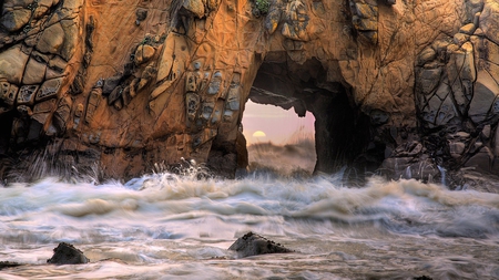 sun thru the rocks on the beach - tunnel, surf, rocks, sun