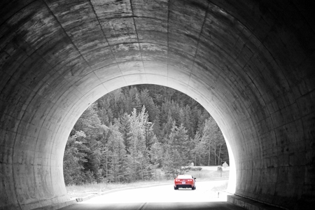 Tunnel vision shot with red car - red, car, tunnel, trees, grey